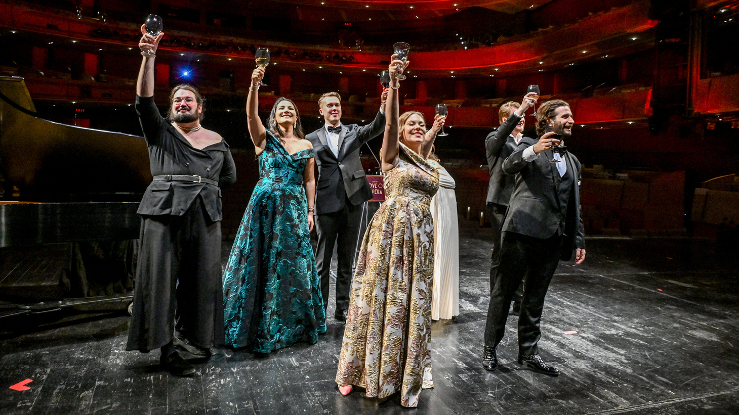 Canadian Opera Company Ensemble Studio Competition performers celebrating on stage raising champagne glasses at the Centre Stage Gala